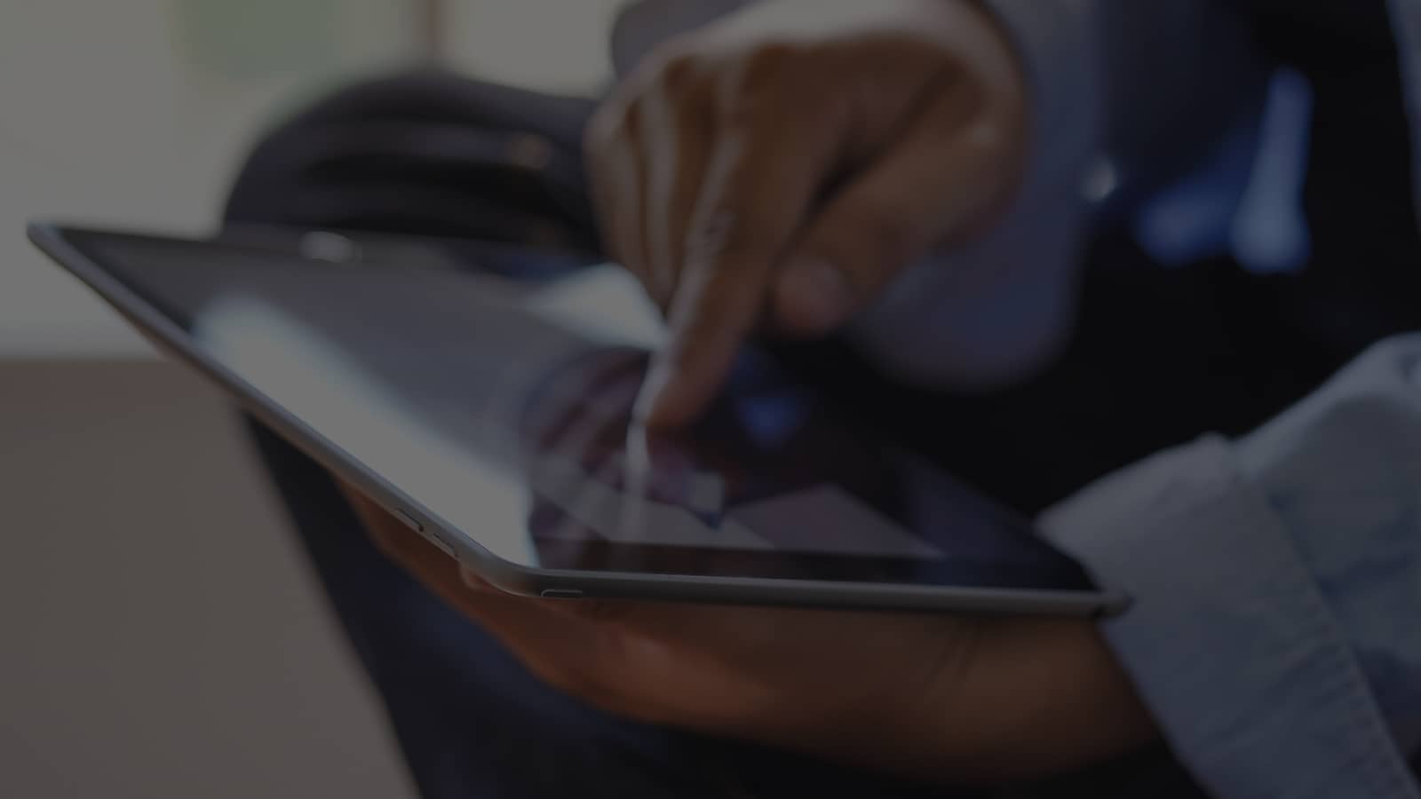 Close-up of hands using tablet device in soft focus