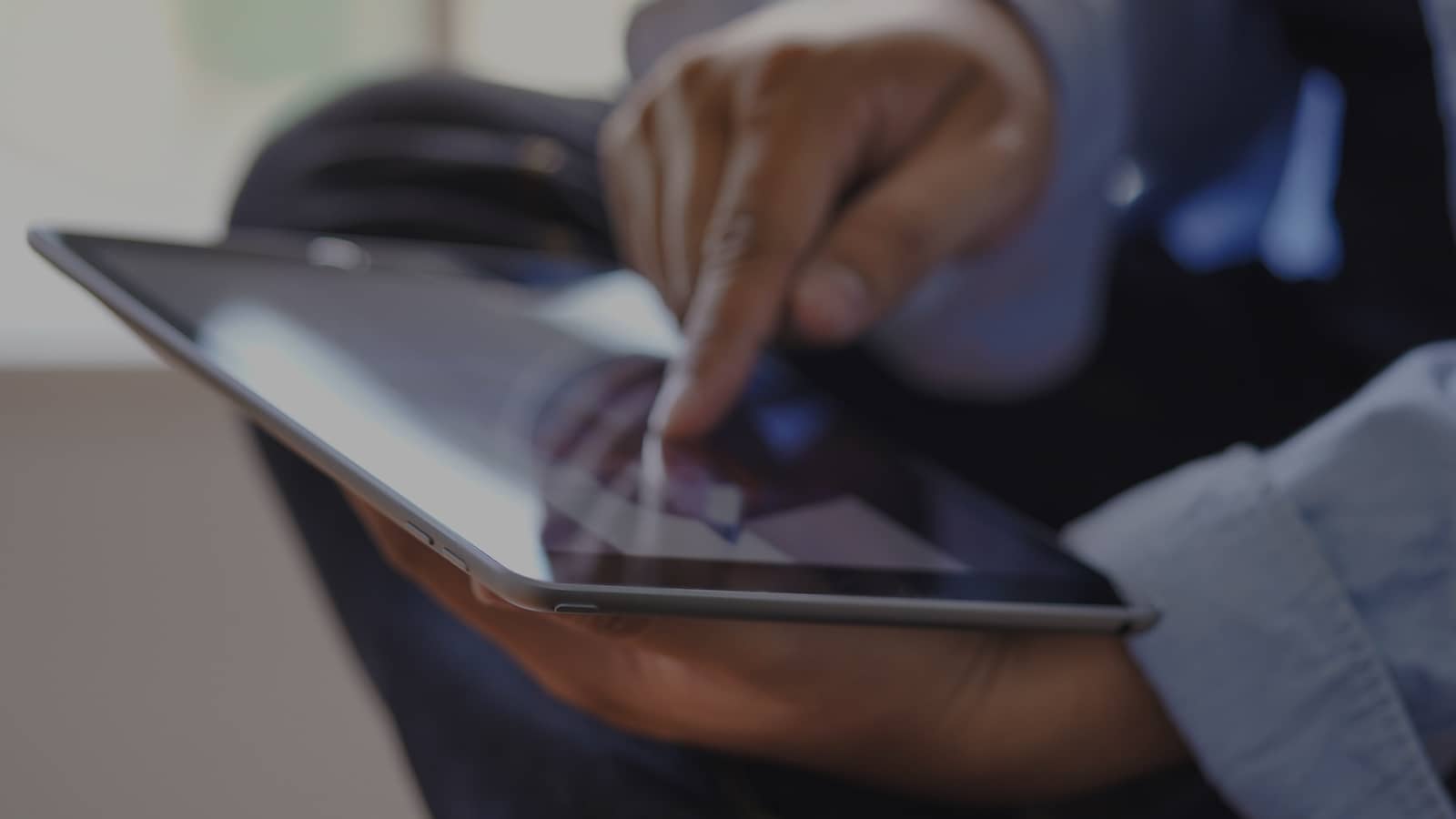 Close-up of hands using tablet device in soft focus Close-up of hands using tablet device in soft focus