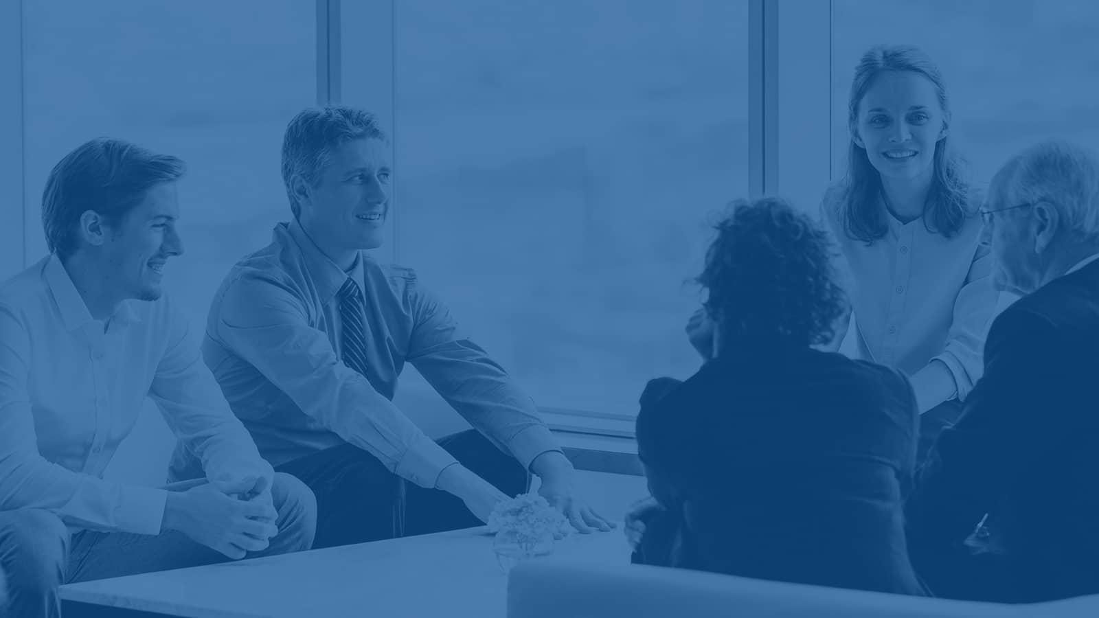 Business professionals talking during team meeting in bright office Business professionals talking during team meeting in bright office